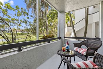 A balcony with a table and chairs